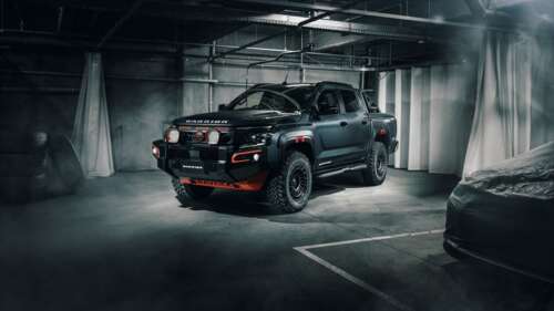 A matte black rugged 2025 off-road pickup truck parked in a concrete parking garage. background images hd