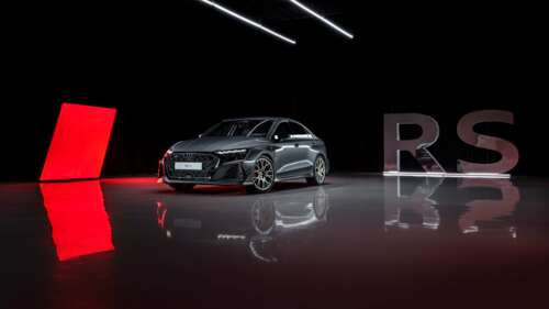 A highly detailed 2026 Audi RS 3 Sedan presented in a moody, dark studio setting. free wallpaper