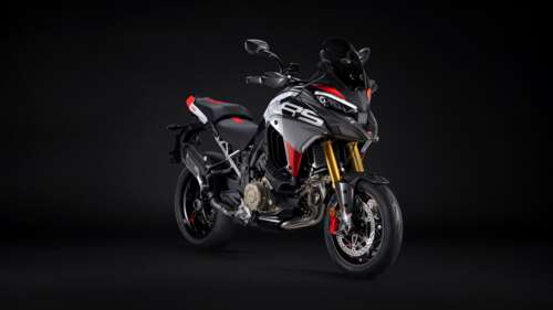 A sleek 2026 Ducati Multistrada V4 RS adventure motorcycle featured against a dark,... high definition wallpaper
