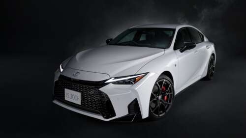 A high-resolution, cinematic shot of a 2026 Lexus IS 300h sedan against a dark, moody... background images hd