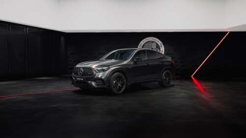A sleek and futuristic 2026 Mercedes-AMG luxury sports car positioned against a dark,... wallpaper
