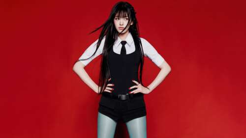 An Yujin from the K-pop group IVE wearing an elegant black dress against a bold red... free desktop wallpaper