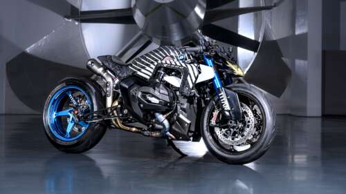 A futuristic BMW R 1300 R Titan adventure motorcycle with a sleek, high-tech metallic... hd background