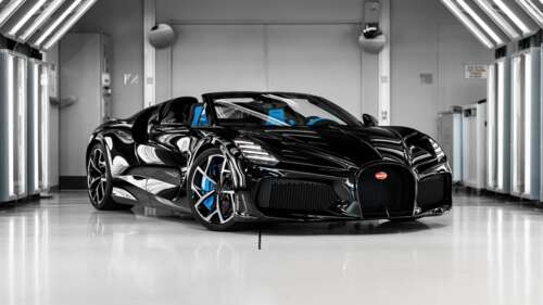 A sleek and powerful black Bugatti W16 Mistral hypercar roadster.