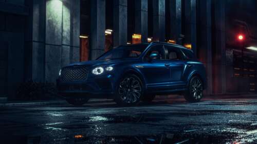 A 2026 Bentley Bentayga EWB driving through a dark urban street at night with city... wallpaper images