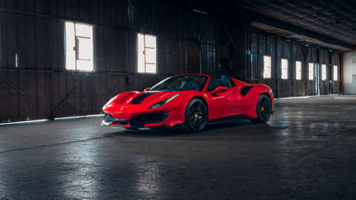 A high-performance red Ferrari 488 Pista supercar showcasing its sleek aerodynamic... wallpaper images