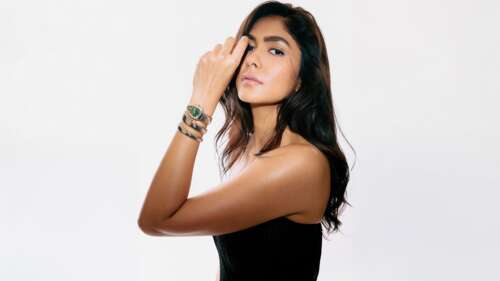 High-resolution portrait of Indian actress Mrunal Thakur wearing a black dress against...