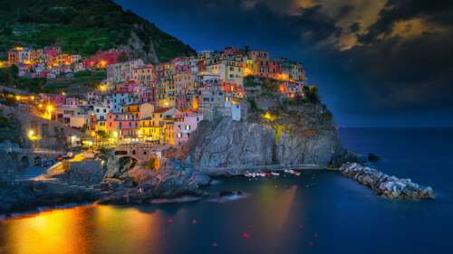 A long exposure view of Manarola village in Cinque Terre, Italy, during blue hour... wallpaper download