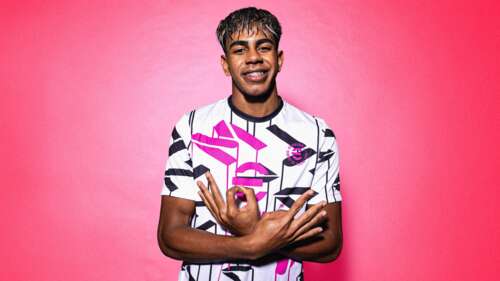 An FC Barcelona football player posed against a bright pink background, featuring... free wallpaper