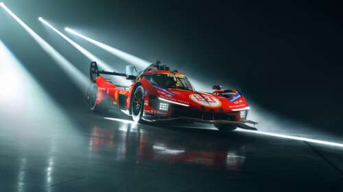 A high-resolution, detailed shot of the Ferrari 499P hypercar featuring futuristic...