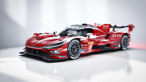 A futuristic 2026 Le Mans Hypercar racing at high speed on a professional track. background images hd