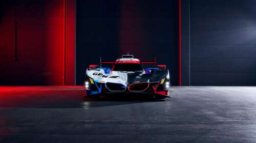 A detailed view of the BMW M Hybrid V8 racing car featuring advanced aerodynamic... free background
