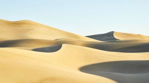 A high-resolution wide shot of golden sand dunes with intricate wind-swept patterns... wallpaper download