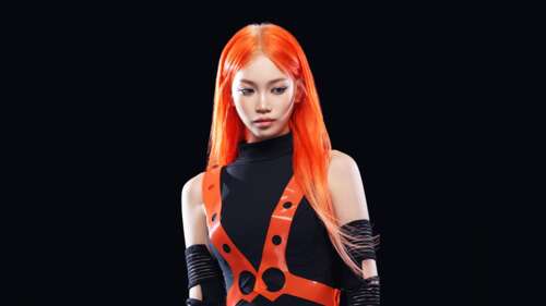 Kim Chaewon from LE SSERAFIM with vibrant orange hair against a black background wallpaper download