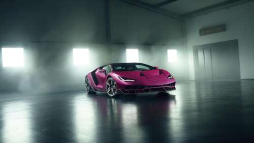 A high-detail shot of the Lamborghini Centenario parked inside a luxury garage as... free wallpaper