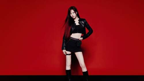 Liz from the K-pop group IVE wearing a stylish black dress against a solid red background wallpaper for laptop download