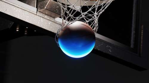 A glowing orange basketball floating near a dark, backlit basketball hoop and backboard... desktop wallpaper