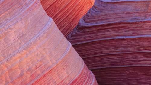 An expansive view of a red sandstone plateau in the Arizona desert under a clear... wallpaper