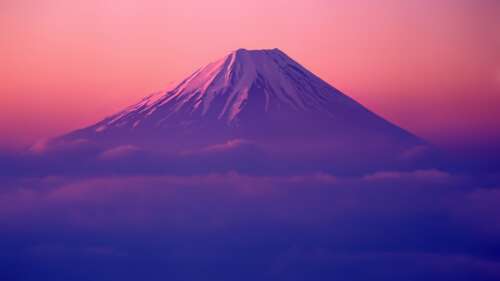 A cinematic landscape featuring Mount Fuji under a sunrise sky with layered clouds,... high definition wallpaper