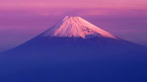 A stunning landscape of Mount Fuji at sunset with a soft pink sky, styled like a... wallpaper download
