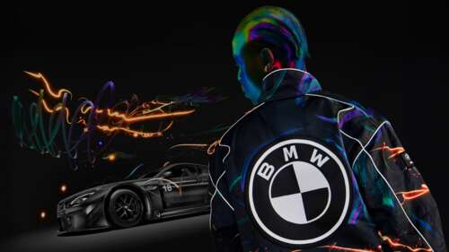 A sleek sports car featuring glowing neon outlines in a dark, high-contrast setting. wallpaper