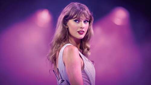 Taylor Swift performing on stage during a live concert featuring a vibrant pink aesthetic... wallpaper