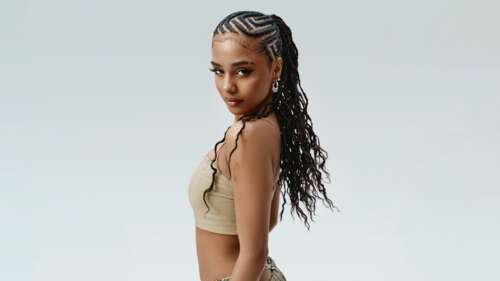 Close-up portrait of South African singer Tyla with detailed braided hair. free wallpaper