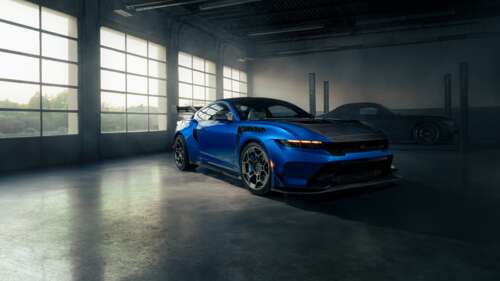 A high-detail 2025 Ford Mustang GTD with Performance Pack parked inside a professional... wallpaper
