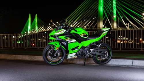 A high-resolution close-up of a 2025 Kawasaki Ninja 500 sports motorcycle featuring...