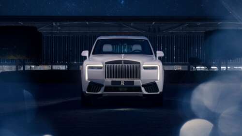 A group of luxury white cars parked in a dark, modern setting at night. free hd wallpapers