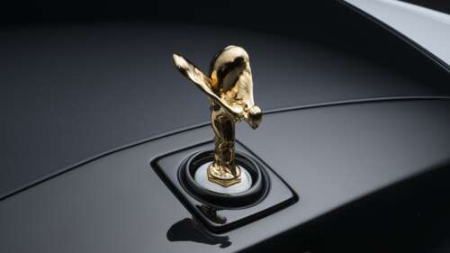 Close-up of the Spirit of Ecstasy ornament on a Rolls-Royce Phantom Centenary. wallpaper