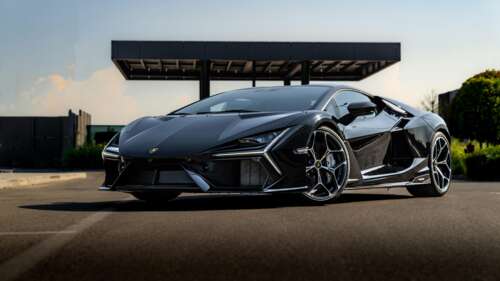 A high-resolution, detailed shot of a glossy black Lamborghini Revuelto supercar. high definition wallpaper