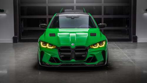 A high-resolution, close-up shot of a modern, aerodynamic green sports car with premium... wallpaper download