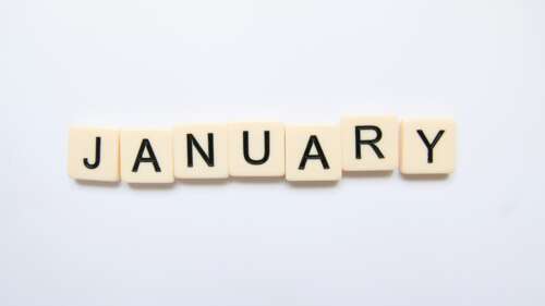 Scrabble tiles spelling the word January on a white background free wallpaper