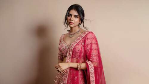 A high-resolution portrait of Indian actress Kalyani Priyadarshan wearing elegant... wallpaper