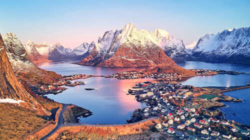 An aerial perspective of the scenic mountains and coastal waters surrounding Reine... wallpaper