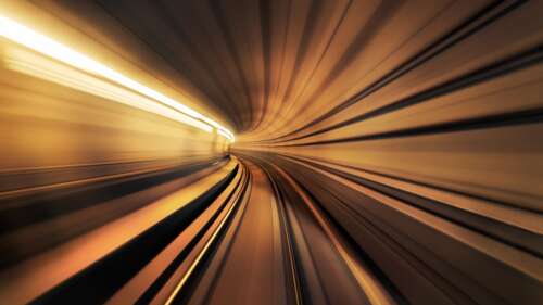 A cinematic view of a warp tunnel featuring intense motion blur and glowing light... desktop wallpaper