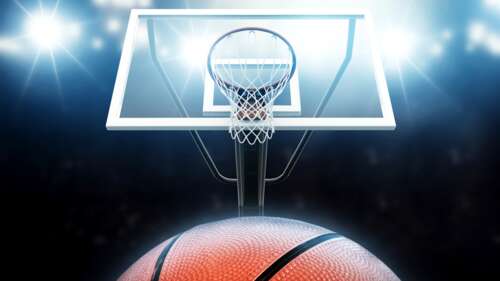 A close-up shot of a basketball hoop and backboard illuminated by dramatic lighting... wallpaper
