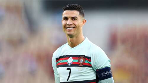 A high-quality 5K close-up portrait of Cristiano Ronaldo smiling. desktop wallpaper