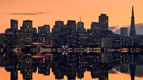 A panoramic view of the San Francisco skyline at sunset with a vibrant orange sky... free hd wallpapers