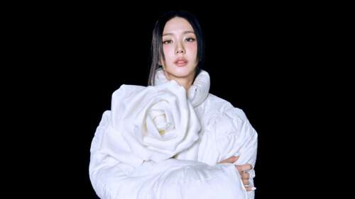 A high-definition portrait of Blackpink's Jisoo wearing a graceful white dress against... wallpaper download