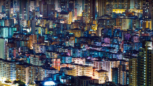 An illuminated cityscape with towering buildings and bright lights under a dark night... wallpaper photo gallery download