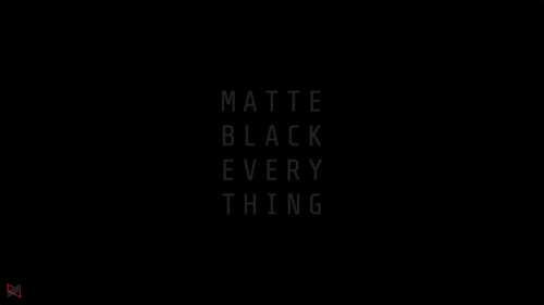 A sleek matte black object with sharp light reflections and deep shadows against... free desktop wallpaper