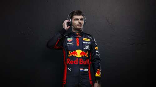 Cinematic portrait of Max Verstappen in Red Bull Racing Formula One gear against...