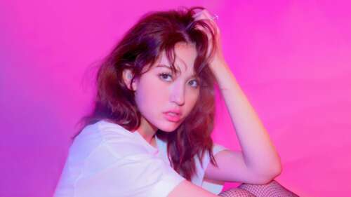 A high-resolution monochromatic pink portrait with a K-pop aesthetic and a soft pink... wallpaper