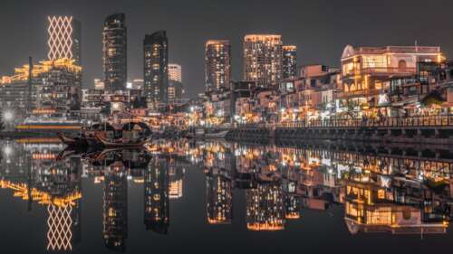 A stunning nighttime view of the Hong Kong city skyline featuring brightly lit skyscrapers... background images hd