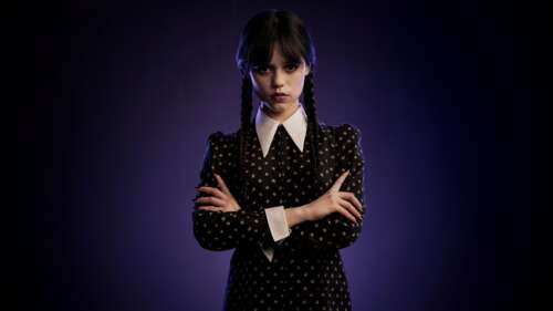 Jenna Ortega as Wednesday Addams from the Netflix series Wednesday against a dark... free wallpaper