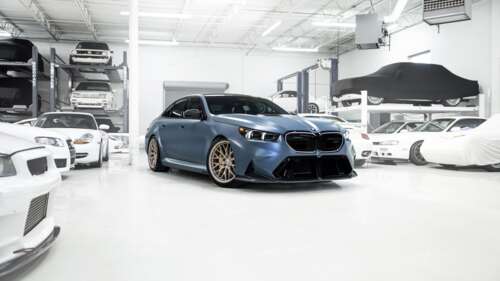 A high-detail, cinematic shot of a BMW M5 luxury sedan showcasing its sleek metallic...