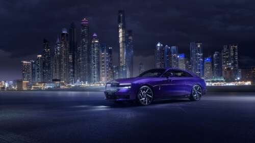 A luxury Rolls-Royce Black Badge Spectre parked in Dubai under a purple aesthetic... wallpaper download