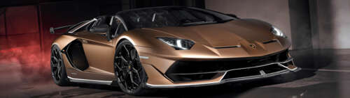 A luxurious brown Lamborghini Aventador SVJ supercar with a glossy finish. Dual UHD wallpaper download